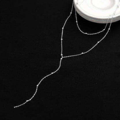Collier long à breloques